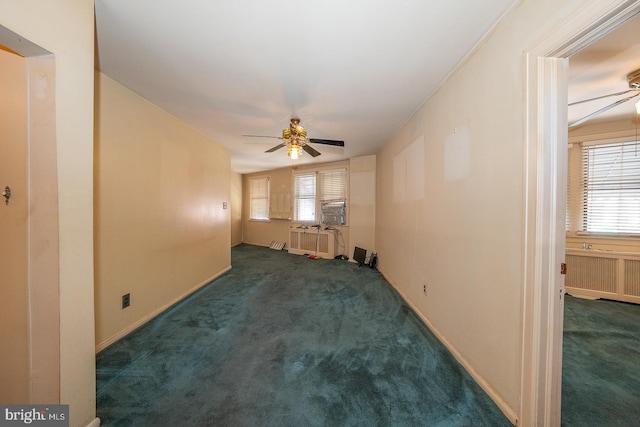 unfurnished living room with a healthy amount of sunlight, carpet, radiator heating unit, and a ceiling fan