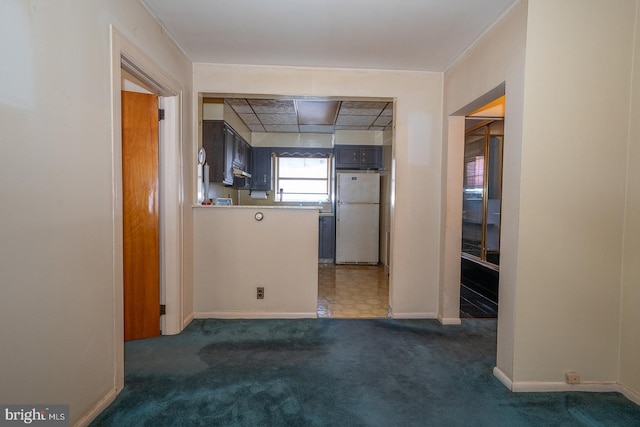 unfurnished room with carpet floors and baseboards