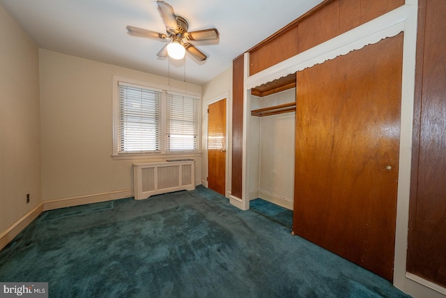 unfurnished bedroom featuring radiator heating unit, a closet, baseboards, and carpet flooring