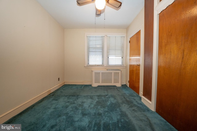 unfurnished room featuring radiator, carpet, baseboards, and ceiling fan