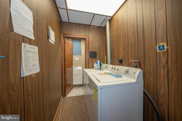 laundry area featuring laundry area, wooden walls, washer hookup, and hookup for an electric dryer