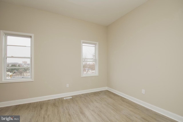 spare room with light hardwood / wood-style flooring