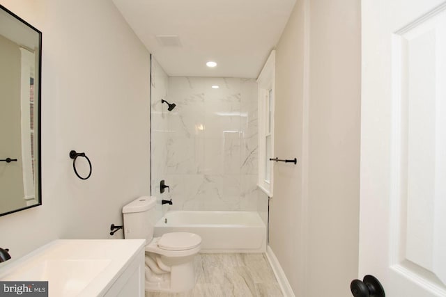 full bathroom featuring tiled shower / bath combo, vanity, and toilet