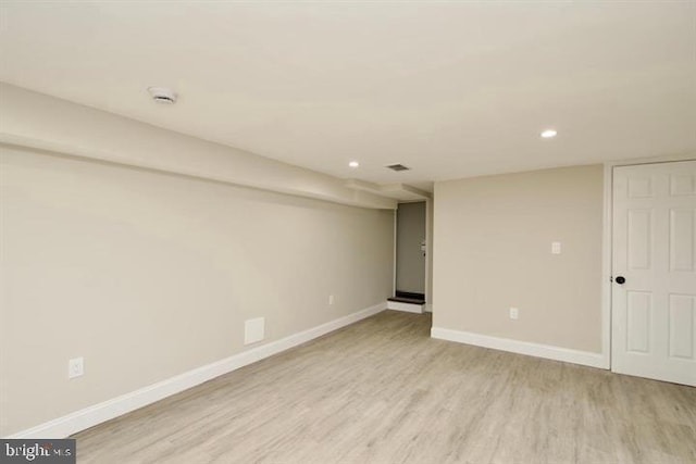 basement with light hardwood / wood-style flooring