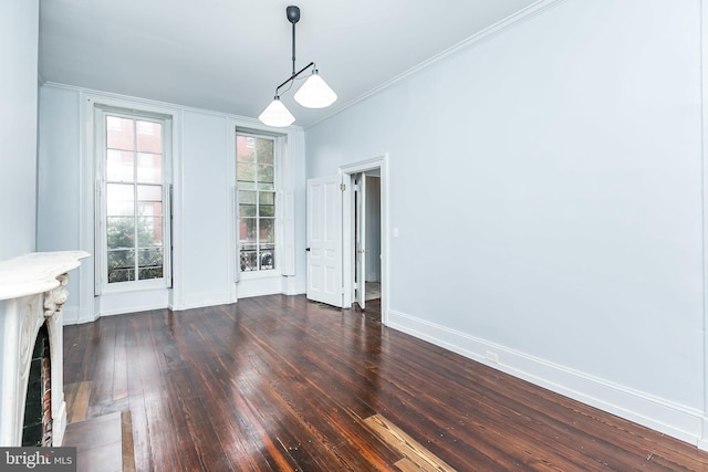 unfurnished dining area featuring a fireplace with flush hearth, baseboards, dark wood finished floors, and crown molding