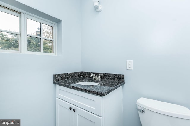 half bathroom featuring toilet and vanity