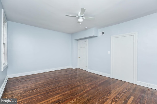 unfurnished room with visible vents, ceiling fan, baseboards, and wood finished floors