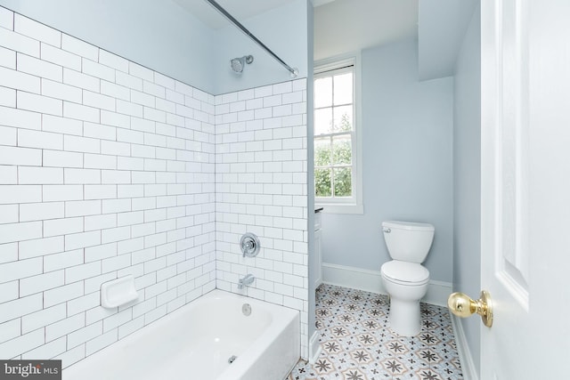 full bathroom featuring toilet, baseboards, and tub / shower combination