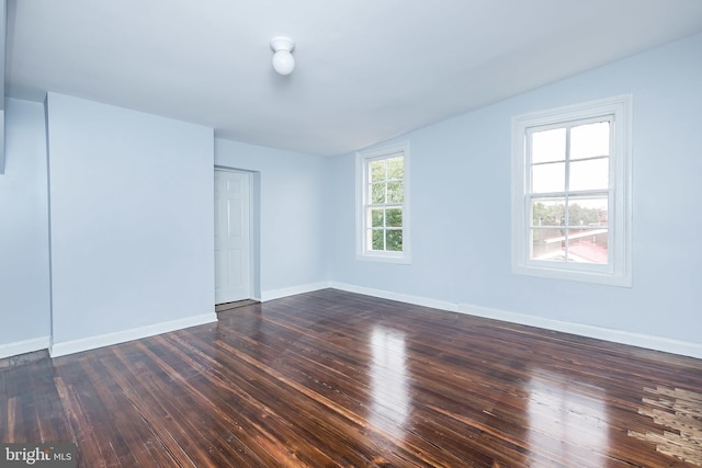 interior space with dark wood finished floors and baseboards