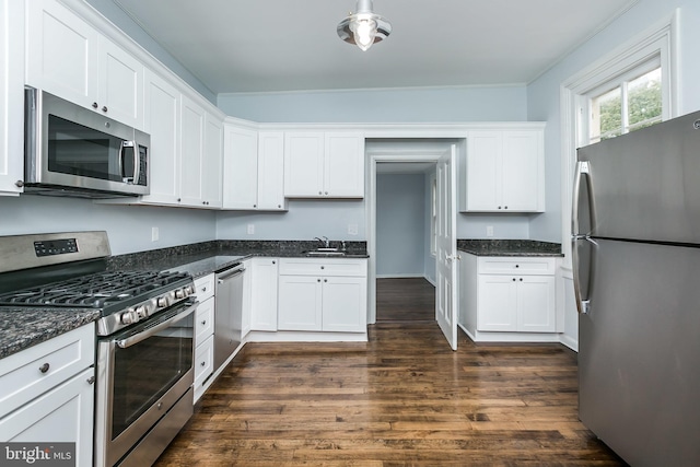 kitchen featuring white cabinets, dark wood-style floors, stainless steel appliances, and a sink