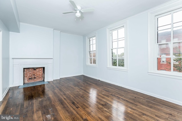 unfurnished living room featuring a fireplace with flush hearth, a ceiling fan, baseboards, hardwood / wood-style floors, and crown molding