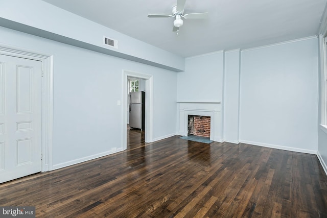 unfurnished living room featuring dark wood-style floors, a fireplace with flush hearth, visible vents, and baseboards