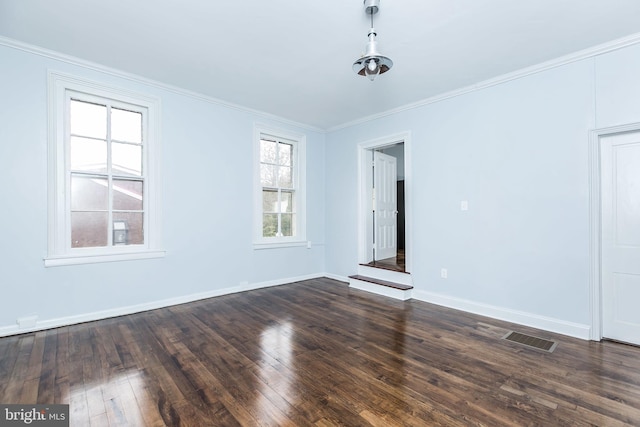 unfurnished room with crown molding, visible vents, baseboards, and dark wood-style flooring