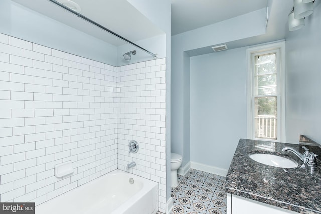 full bath with toilet, visible vents, bathing tub / shower combination, vanity, and baseboards