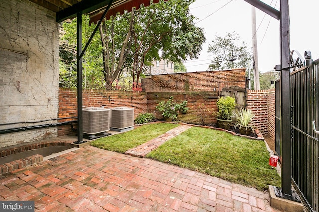 view of yard with central AC, a patio, and a fenced backyard