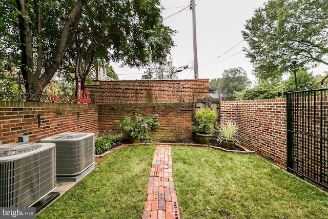 view of yard with a fenced backyard and central air condition unit