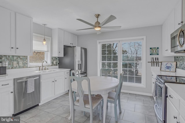 3 Ingram Bay Dr, Heathsville, VA 22473 - kitchen featuring light countertops, a sink, ceiling fan, white cabinets, and appliances with stainless steel finishes