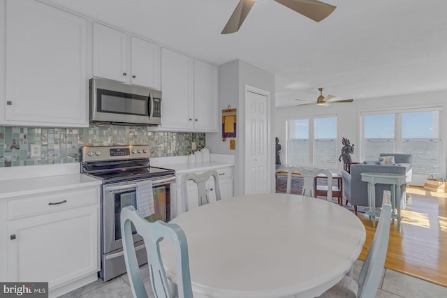 3 Ingram Bay Dr, Heathsville, VA 22473 - kitchen with white cabinets, ceiling fan, appliances with stainless steel finishes, and decorative backsplash