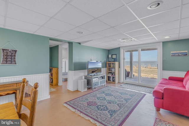 3 Ingram Bay Dr, Heathsville, VA 22473 - living area featuring a wainscoted wall, visible vents, concrete floors, and a paneled ceiling