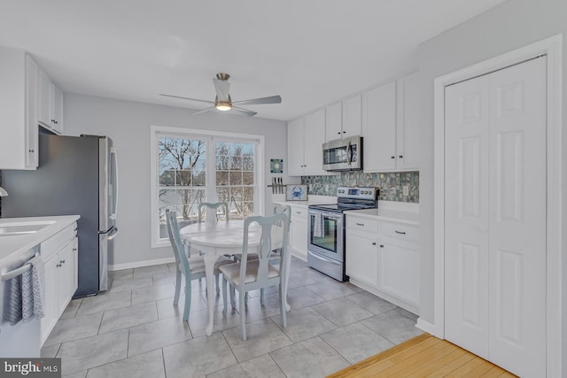 3 Ingram Bay Dr, Heathsville, VA 22473 - kitchen with light countertops, backsplash, appliances with stainless steel finishes, white cabinets, and ceiling fan