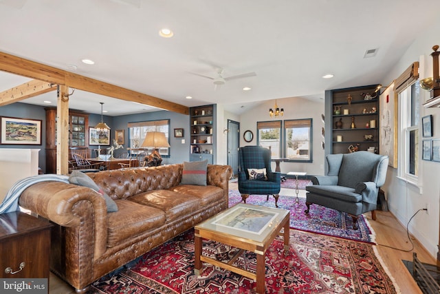 living room featuring wood-type flooring, a chandelier, and lofted ceiling with beams