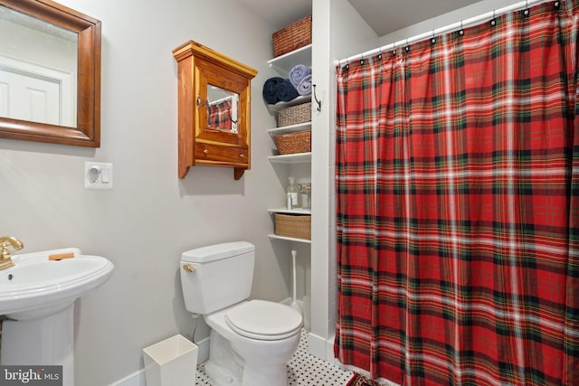 bathroom featuring curtained shower and toilet