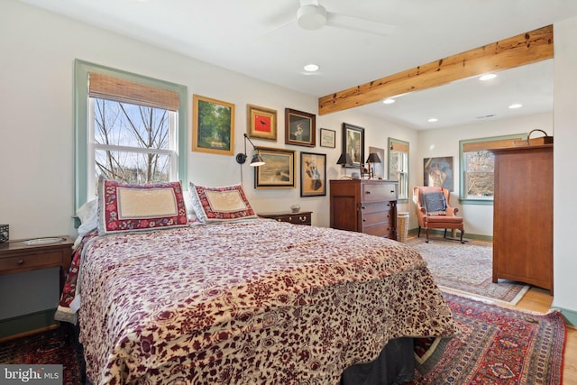 bedroom featuring light hardwood / wood-style flooring and beamed ceiling