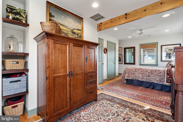 bedroom featuring beamed ceiling and light hardwood / wood-style floors