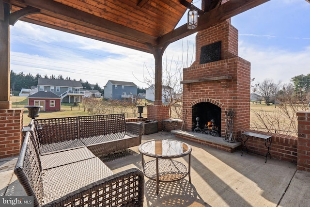 view of patio featuring an outdoor brick fireplace