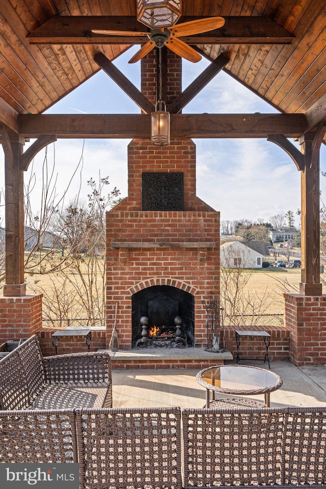 view of patio with an outdoor brick fireplace