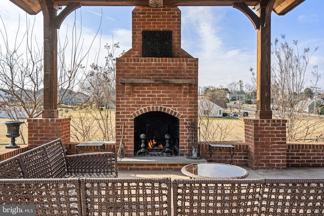 view of patio featuring an outdoor brick fireplace