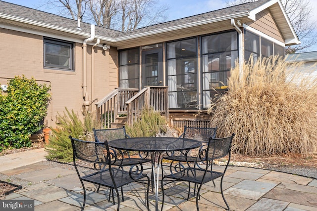 view of patio with a sunroom