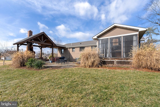 view of yard featuring a gazebo, a patio area, and a sunroom