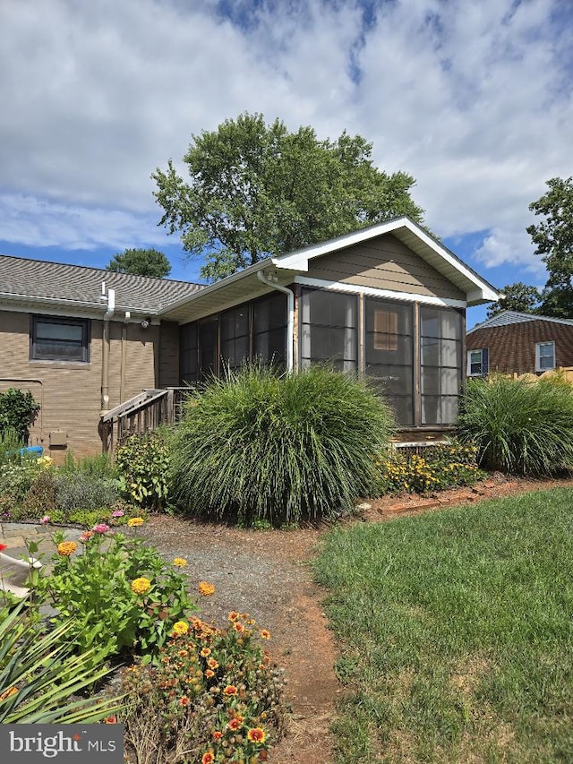 view of front of home featuring a sunroom