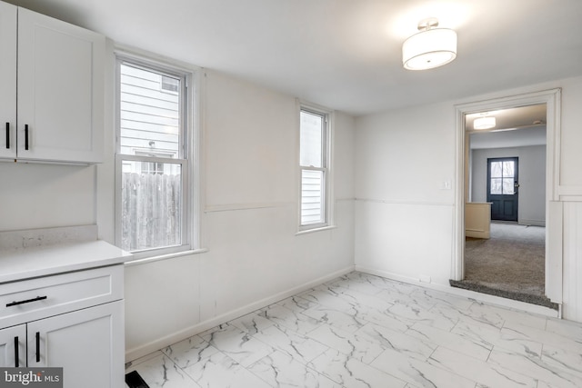 empty room with marble finish floor and baseboards