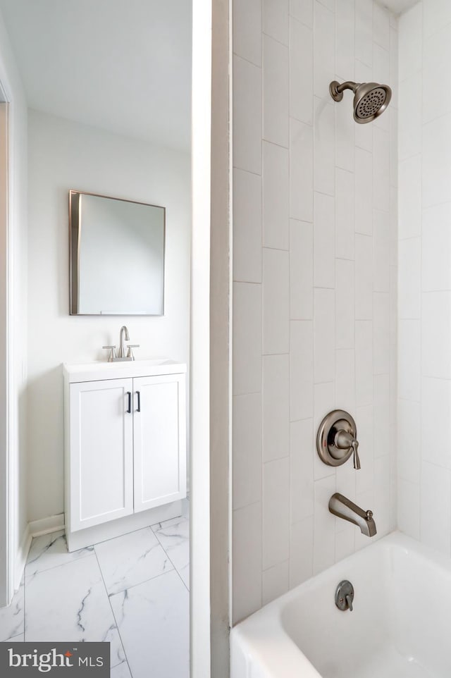 bathroom with marble finish floor, vanity, and shower / bathtub combination