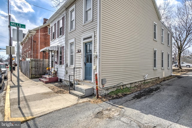 view of side of home featuring fence