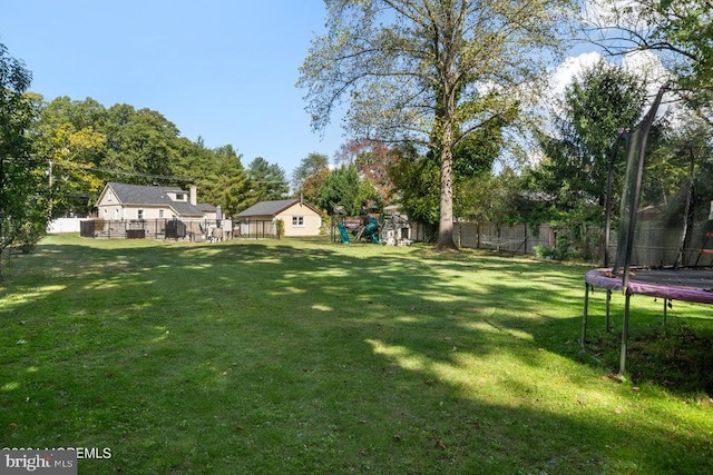 view of yard featuring a playground and a trampoline