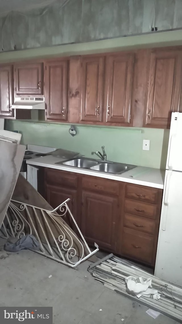 kitchen featuring white fridge and sink