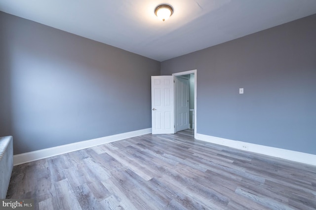 empty room with light hardwood / wood-style flooring