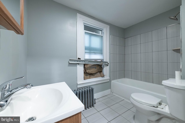 full bathroom featuring radiator heating unit, vanity, tile patterned floors, toilet, and tiled shower / bath