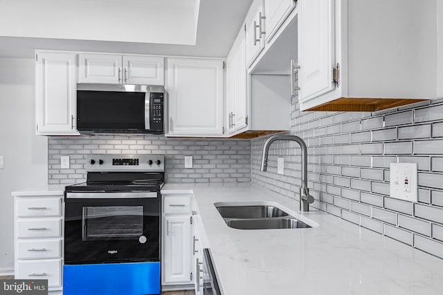 kitchen featuring sink, white cabinets, backsplash, and electric stove