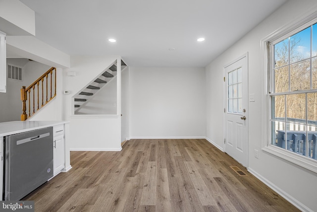 entryway featuring light wood-type flooring and a wealth of natural light