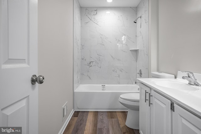 full bathroom with vanity, toilet, tiled shower / bath combo, and wood-type flooring