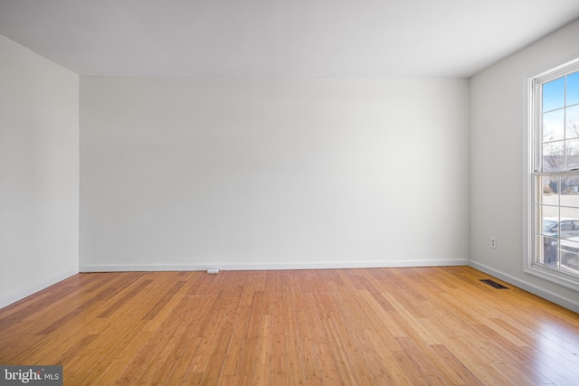 empty room with light hardwood / wood-style floors