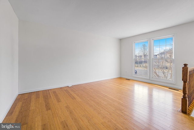 spare room with light hardwood / wood-style floors