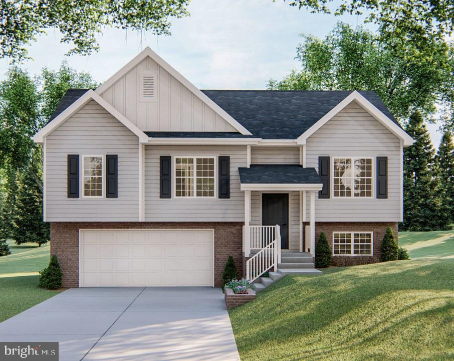 split foyer home featuring a garage and a front lawn