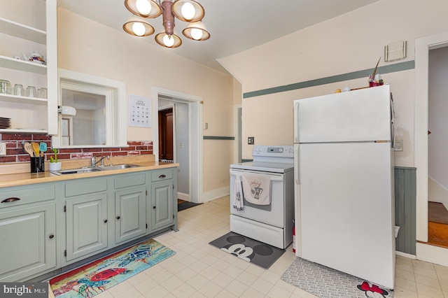 kitchen featuring sink, a notable chandelier, white appliances, and decorative backsplash