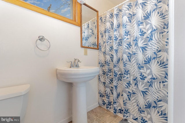 bathroom featuring sink, tile patterned floors, and toilet