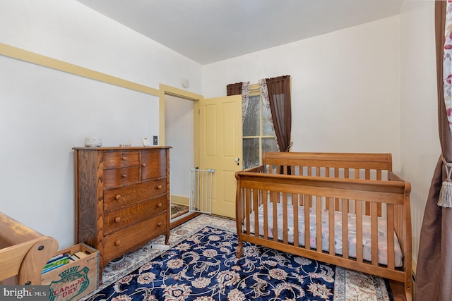 bedroom featuring a crib